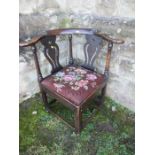An Antique oak corner chair, with pierced splats