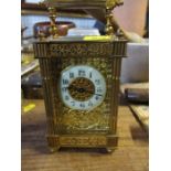 A gilt metal cased carriage clock, with enamel chapter ring and pierced decoration, height including