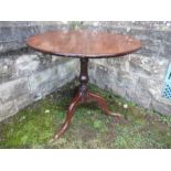 A 19th century oak tilt top tripod table, diameter 31ins x height 28ins