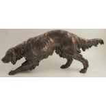 A Continental white metal model, of a dog, eagle stamp to one foot, height 9.5ins, length 24.5ins