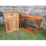 A pine cabinet, having cupboard door below a drawer, width 27ins x depth 14ins x height 39ins,