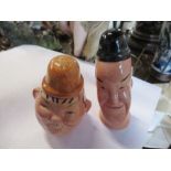 A pair of Beswick novelty salt and pepper pots, formed as Laurel and Hardy, height 3.75ins and down