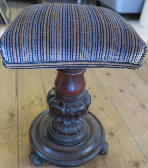 A Victorian mahogany adjustable piano stool, with square upholstered top, on carved column and