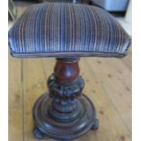A Victorian mahogany adjustable piano stool, with square upholstered top, on carved column and