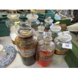 A quantity of  apothecary glass jars and stoppers, some labelled,