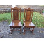 A pair of antique oak hardwood chairs