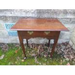 An antique oak side table, with frieze drawer, raised on turned legs terminating in pad feet,