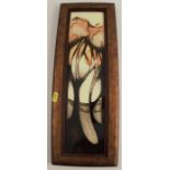 A Moorcroft Pottery rectangular plaque, dated 2005, framed, overall size 19ins x 7ins