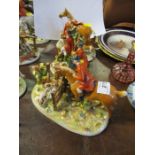 Three German porcelain fox hunting groups, of various figures in pink with horses, hounds and fox,