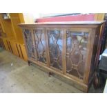 A mahogany glazed bookcase, having two sets of astragal glazed doors, opening to reveal adjustable