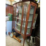 An Edwardian bow fronted mahogany display cabinet, the doors opening to reveal shelves, width