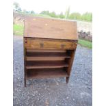 A narrow oak bureau, the fall flap opening to reveal pigeonholes, width 30ins x depth 12ins x height