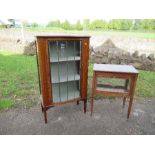 An Edwardian style display cabinet, the leaded glazed serpentine shaped door opening to reveal