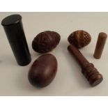 A collection of treen, to include three egg, two being carved, a cylindrical case and other cases