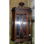 An Edwardian mahogany hanging corner cabinet, with glazed door