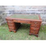 An oak twin pedestal desk, having three frieze drawers above three drawers to each pedestal, with