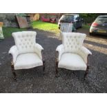 A pair of deep button back armchairs
