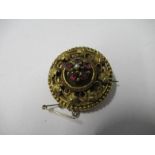 A Victorian gold locket back brooch, with a garnet cluster centre, 3.2cm diameter, 8.3g gross