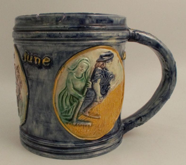 An Edward Bingham Castle Hedingham pottery tankard, decorated in relief with three roundels