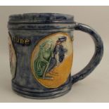 An Edward Bingham Castle Hedingham pottery tankard, decorated in relief with three roundels
