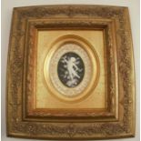 A Minton oval porcelain pate sur pate plaque or plate centre, decorated with a white cherub to a