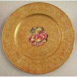 A Royal Worcester plate, decorated with a hand painted fruit centre by Henry, to an acid gilt