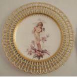 A Minton porcelain cabinet plate, with pierced border, the centre decorated with a semi naked