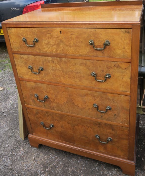 A 20th century walnut chest, of four long drawers, raised on bracket feet, width 31ins, depth 18.