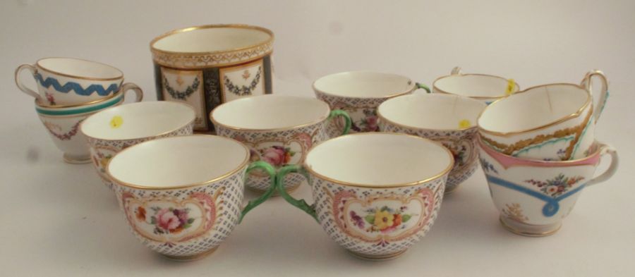 A circular 19th century cache pot, decorated with reserve panels of flowers to an en grisaille