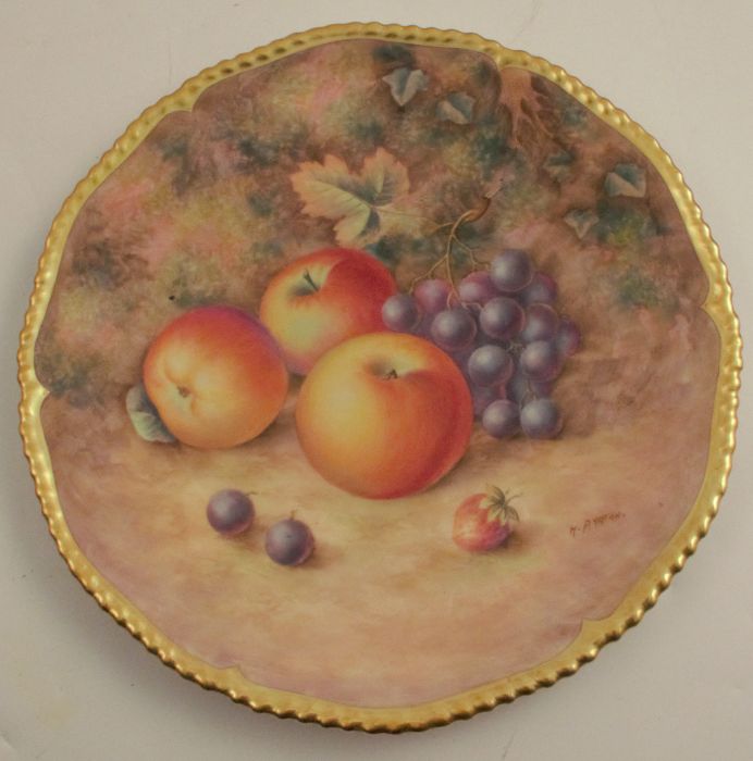A Royal Worcester cabinet plate, decorated with fruit to a mossy background by H Aryton, with gilt