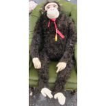 A toy monkey, with black plush fur and kid face, hands and feet, height 45ins