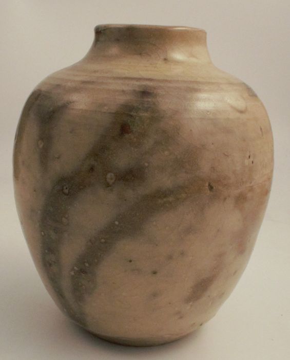 A studio pottery vase, decorated with a beige glaze, marked CH to base, height 7ins