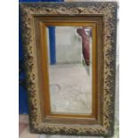 A wall mirror, with engraved urn decoration, with carved frame, overall 33.5ins x 21.5ins