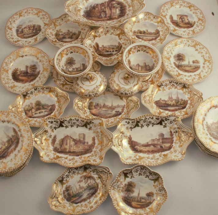 An extensive 19th century Spode service, decorated with named landscape panels to gilt borders,