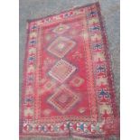 An Antique rug, the red ground decorated with hooked gulls, 82ins x 54ins