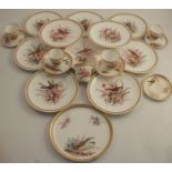 A collection of 19th century Worcester plates, cups and saucers, decorated with birds and foliage,