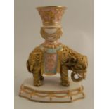 A 19th century Royal Worcester table centre piece, formed as a Persian style gold elephant, with a