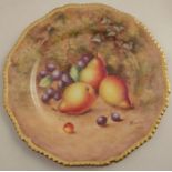 A Royal Worcester cabinet plate, decorated with fruit to a mossy background by Freeman, with