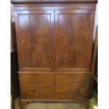 A 19th century mahogany linen press, the pair of doors opening to reveal a hanging space, linen