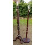 A mahogany standard lamp, with wrythen column, carved with leaves, on three outswept supports,