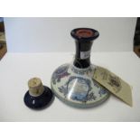 A sealed Wade porcelain Nelson's ship decanter, top damaged, containing British Navy Pussers Rum,