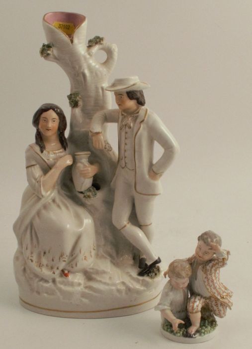 A Staffordshire figure group spill vase, of a couple by a tree, height 12ins, together with a