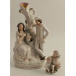 A Staffordshire figure group spill vase, of a couple by a tree, height 12ins, together with a