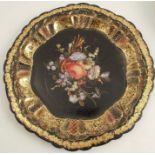 A papier mache plate, with inlaid mother of pearl floral decoration, to a gilt border, diameter 10.
