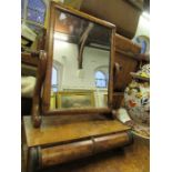 A mahogany swing frame toilet mirror