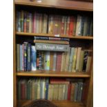 A collection of books, including Dornford Yates, and John Buchan, together with leather bound
