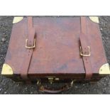 A Cogswell & Harrison leather and brass bound gun cartridge case, with leather straps, the