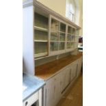 An Antique painted pine dresser, the base fitted with four drawers over cupboards with fielded