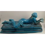 A large English majolica model, of a semi naked female lying on her front, on a rectangular plinth