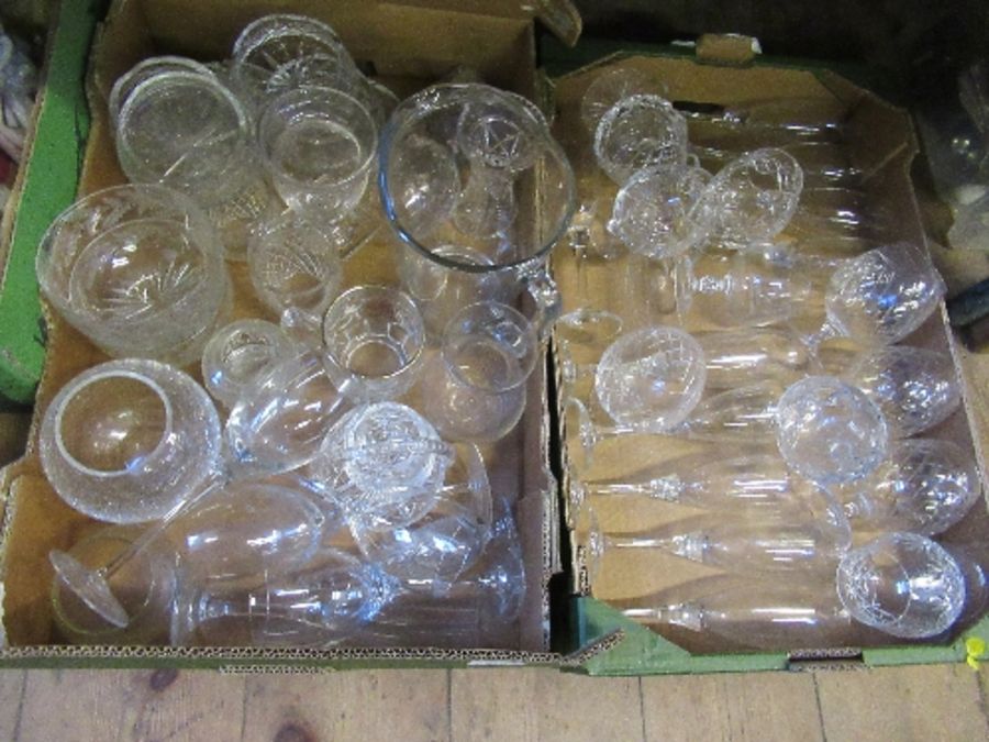 Two boxes of assorted glass, to include flutes, jug, etc.